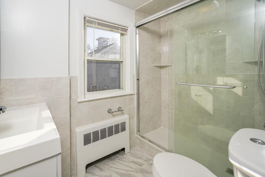 1309 Washington Street Canton, MA 02021 - Photo 14 of 35 a bathroom with a sink and a mirror