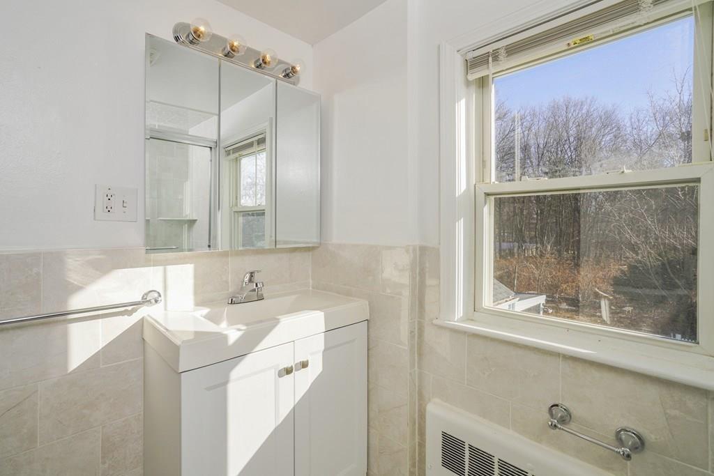 1309 Washington Street Canton, MA 02021 - Photo 15 of 35 a bathroom with a sink mirror and a shower