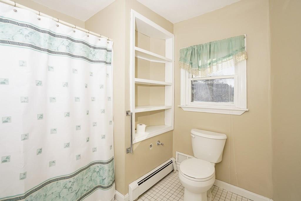 1309 Washington Street Canton, MA 02021 - Photo 19 of 35 a bathroom with a toilet and a shower curtain