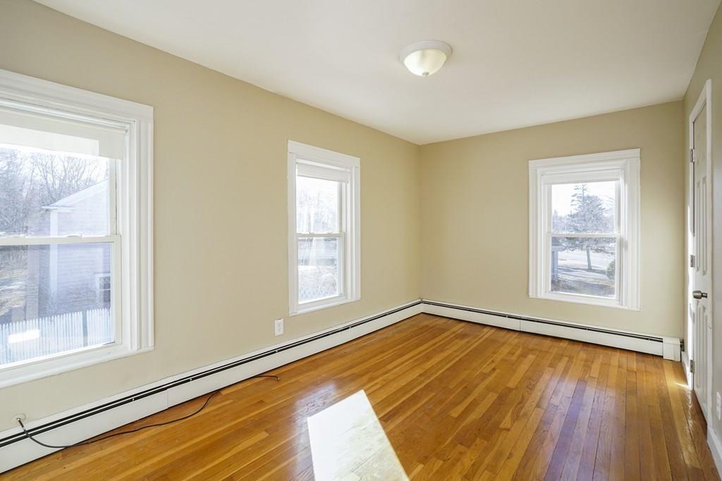 1309 Washington Street Canton, MA 02021 - Photo 20 of 35 a view of an empty room with a window and wooden floor