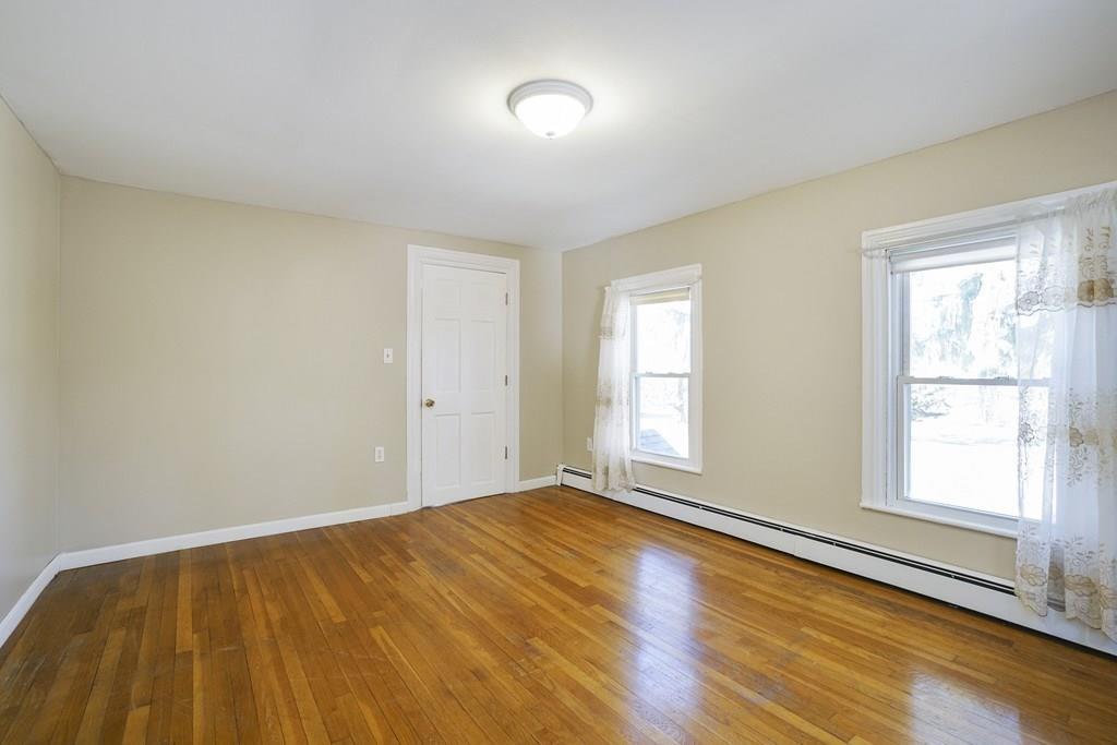 1309 Washington Street Canton, MA 02021 - Photo 23 of 35 a view of an empty room with wooden floor and a window