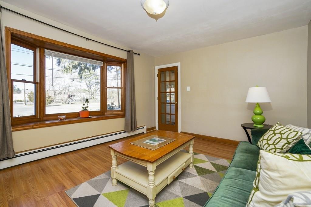 1309 Washington Street Canton, MA 02021 - Photo 5 of 35 a living room with a bed and a large window