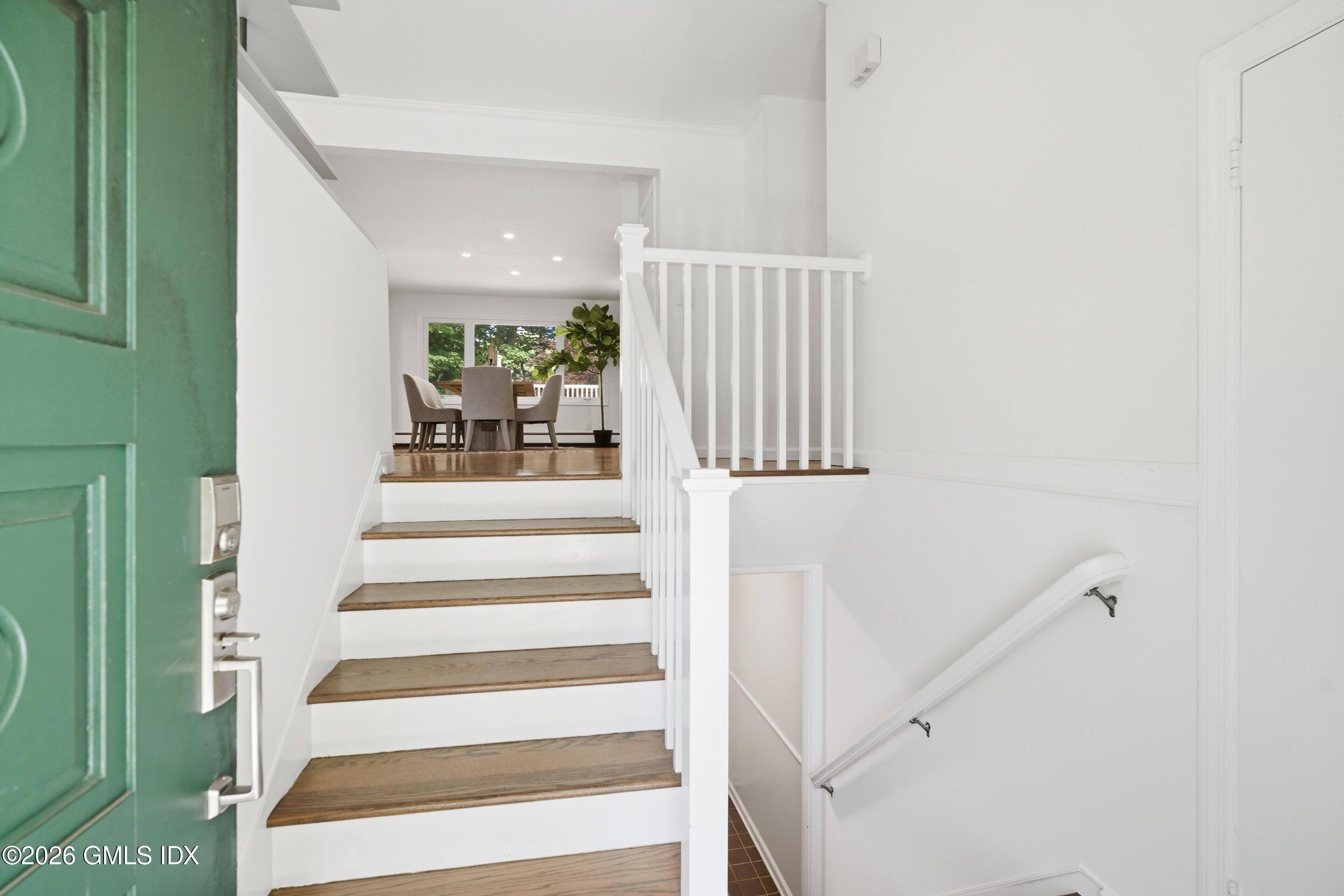 33 Sachem Road Greenwich, CT 06830 - Photo 2 of 35 a view of staircase with white walls and a window