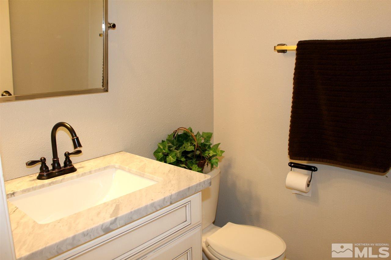 3824 Bexley Square Reno, NV 89503 - Photo 14 of 25 a bathroom with a sink a toilet and mirror