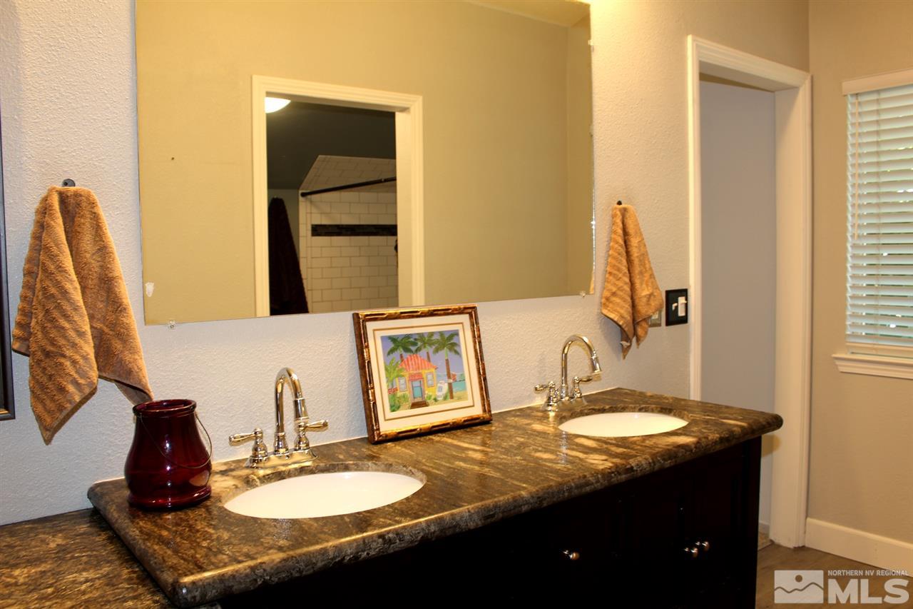 3824 Bexley Square Reno, NV 89503 - Photo 23 of 25 a bathroom with a granite countertop sink and a mirror