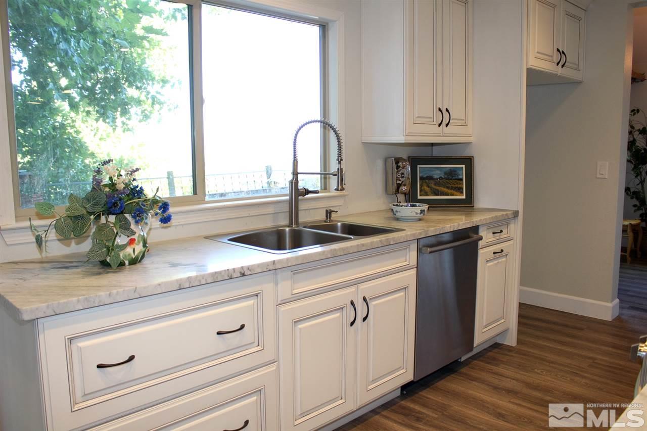 3824 Bexley Square Reno, NV 89503 - Photo 5 of 25 a kitchen with granite countertop white cabinets and a sink