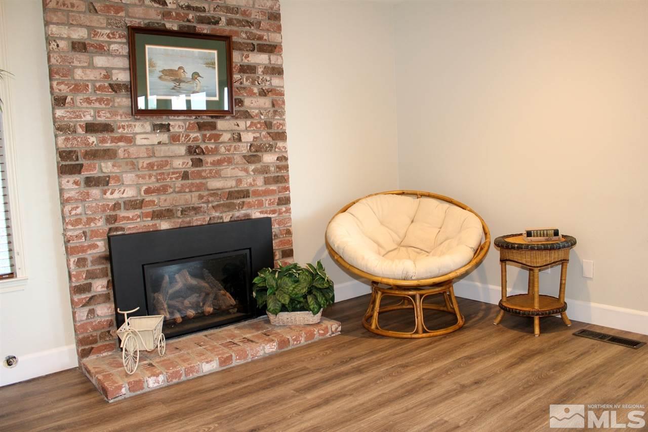 3824 Bexley Square Reno, NV 89503 - Photo 8 of 25 a room with wooden floor and a fireplace