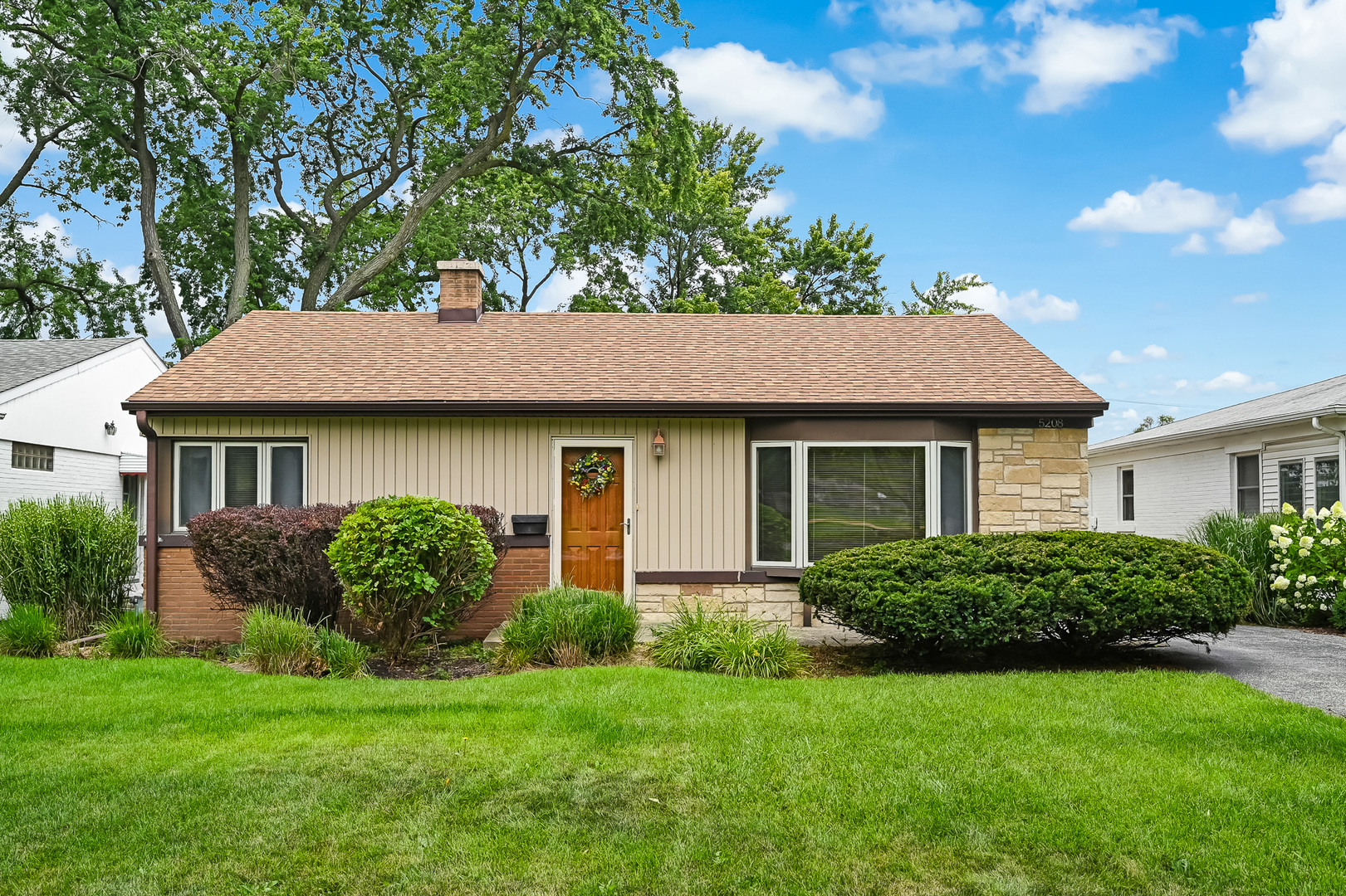 5208 Wolf Road Western Springs, IL 60558 - Photo 1 of 18 a front view of a house with a garden