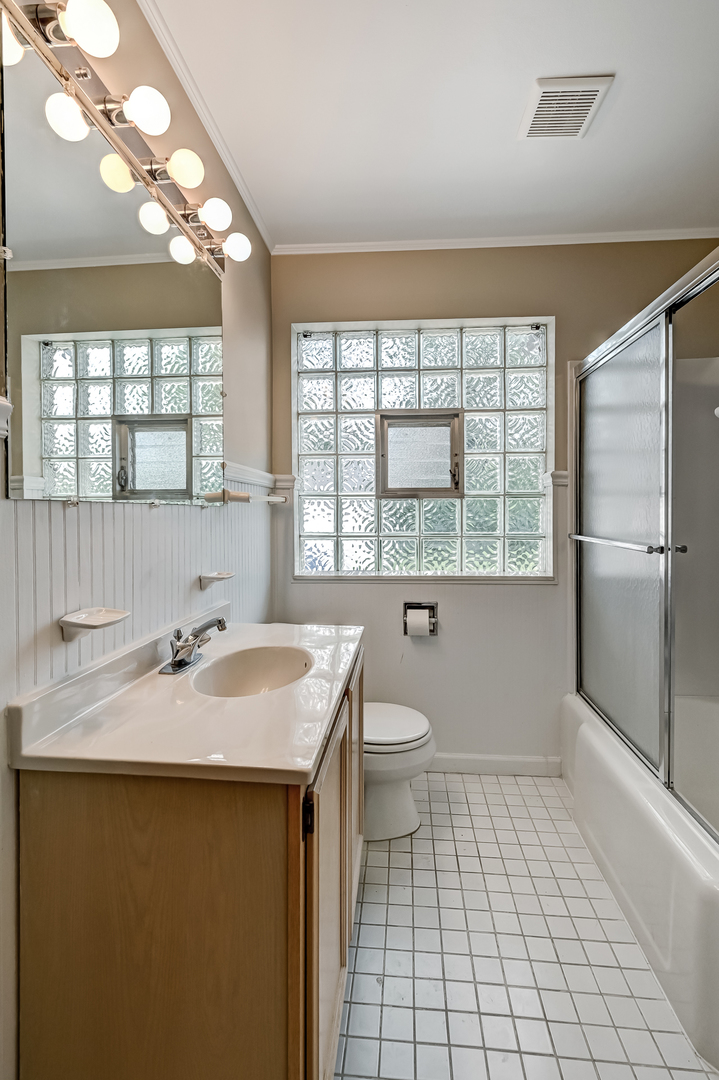5208 Wolf Road Western Springs, IL 60558 - Photo 6 of 18 a bathroom with a sink toilet and vanity
