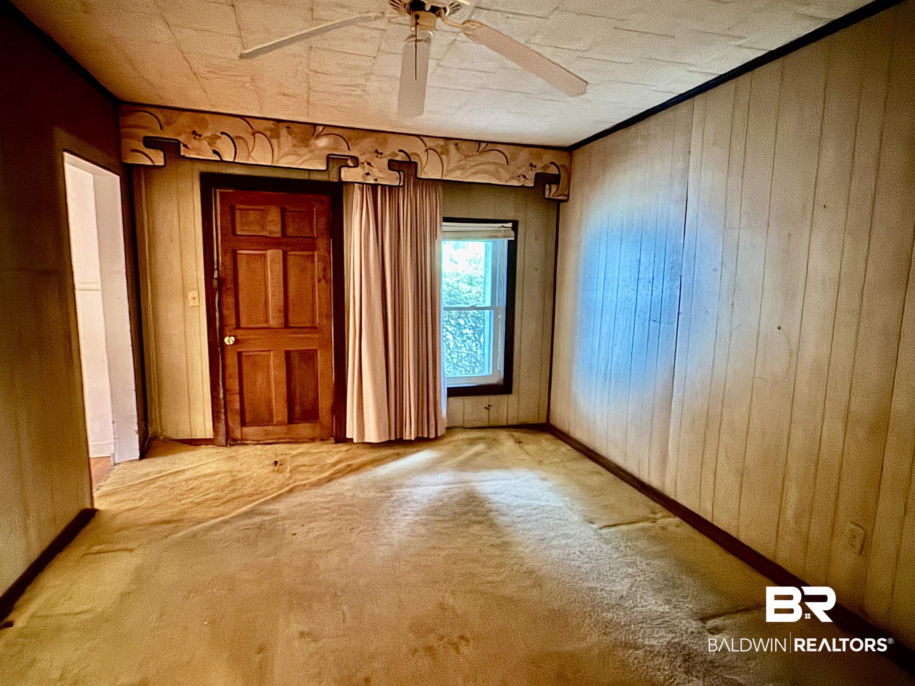 42186 Nicholsville Road Bay Minette, AL 36507 - Photo 6 of 10 Carpeted empty room featuring ceiling fan and wooden walls
