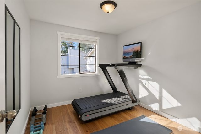 a room with gym equipment and a flat screen tv
