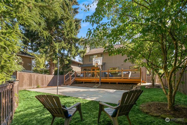 a view of house with backyard outdoor seating and green space