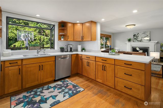 a kitchen with sink cabinets and appliances