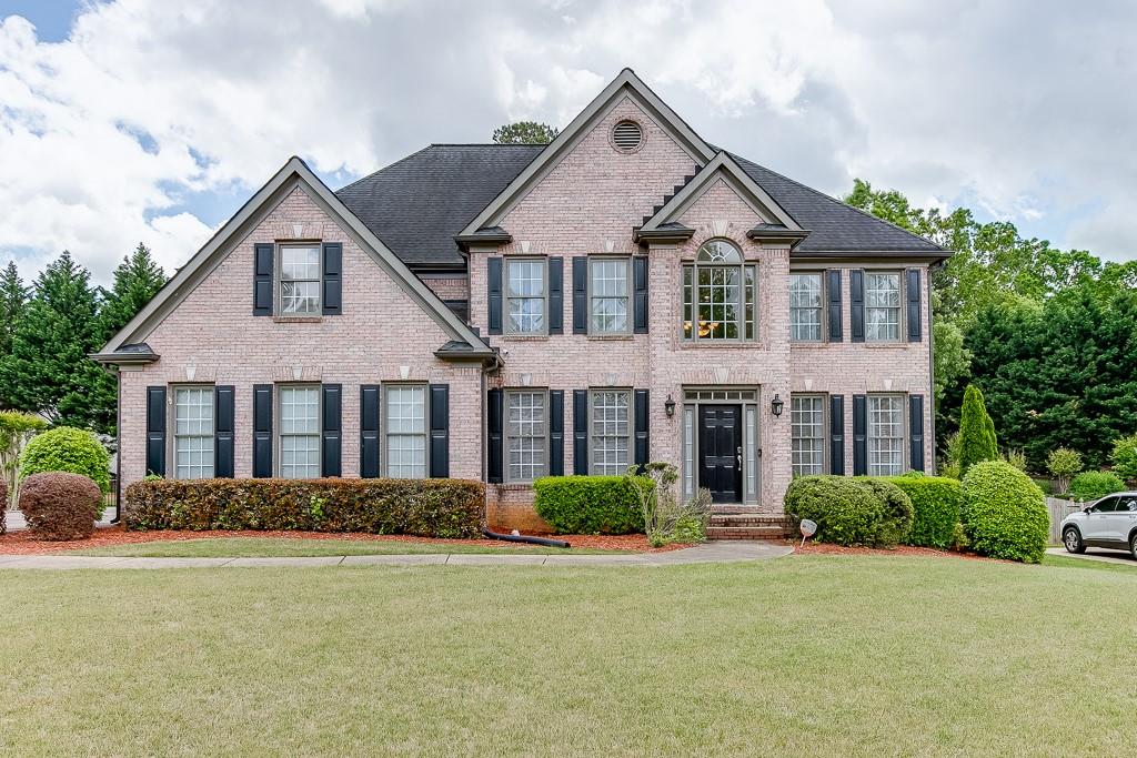 940 Sentry Ridge Crossing Suwanee, GA 30024 - Photo 1 of 1 a front view of a house with a yard and garage