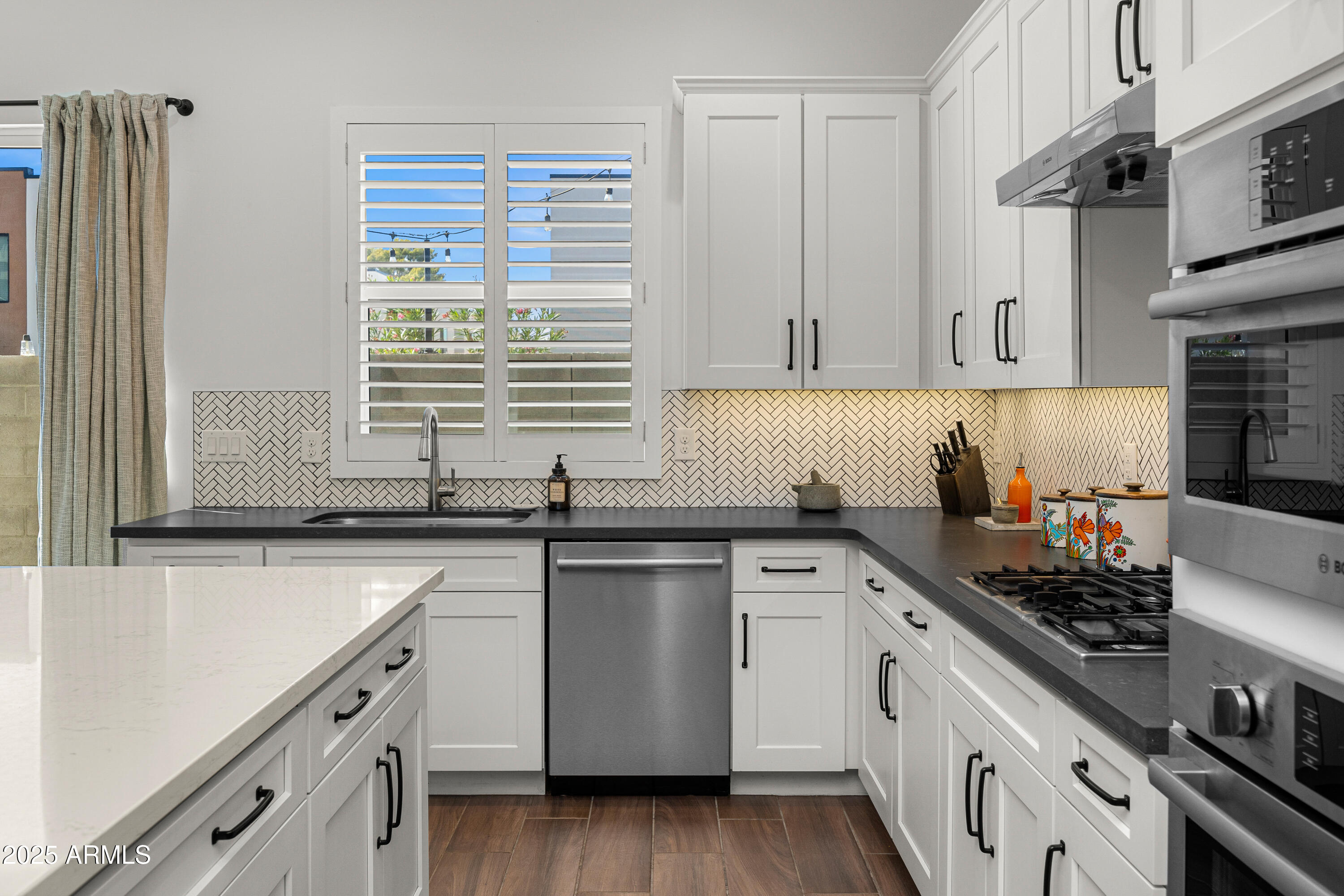 3200 North 39th Street, Unit 11 Phoenix, AZ 85018 - Photo 6 of 24 a kitchen with stainless steel appliances granite countertop a sink stove and cabinets