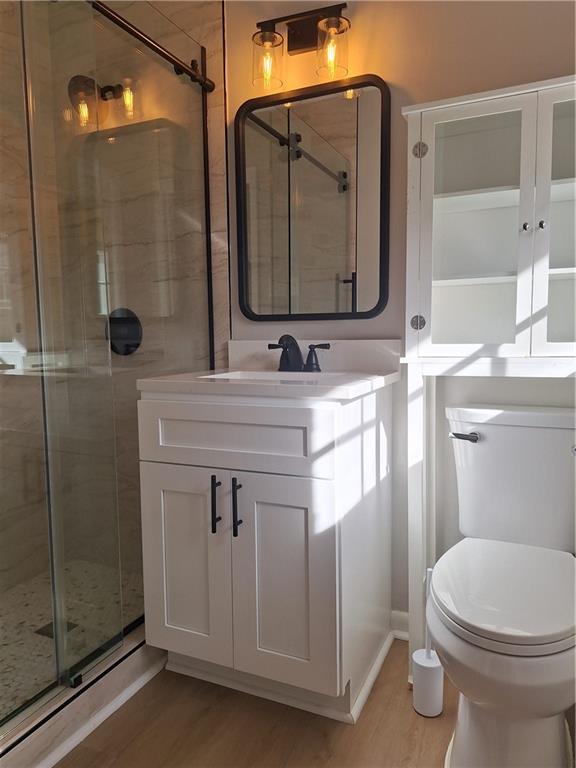 1605 Brockett Road Tucker, GA 30084 - Photo 3 of 12 a bathroom with a toilet sink vanity and mirror