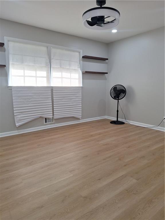 1605 Brockett Road Tucker, GA 30084 - Photo 4 of 12 a view of an empty room with wooden floor and a window