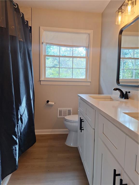 1605 Brockett Road Tucker, GA 30084 - Photo 7 of 12 a bathroom with a sink a toilet and a mirror