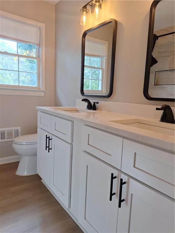 1605 Brockett Road Tucker, GA 30084 - Photo 8 of 12 a bathroom with a toilet sink and mirror