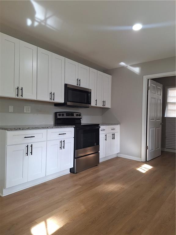 1605 Brockett Road Tucker, GA 30084 - Photo 9 of 12 a kitchen with granite countertop a refrigerator and a stove top oven