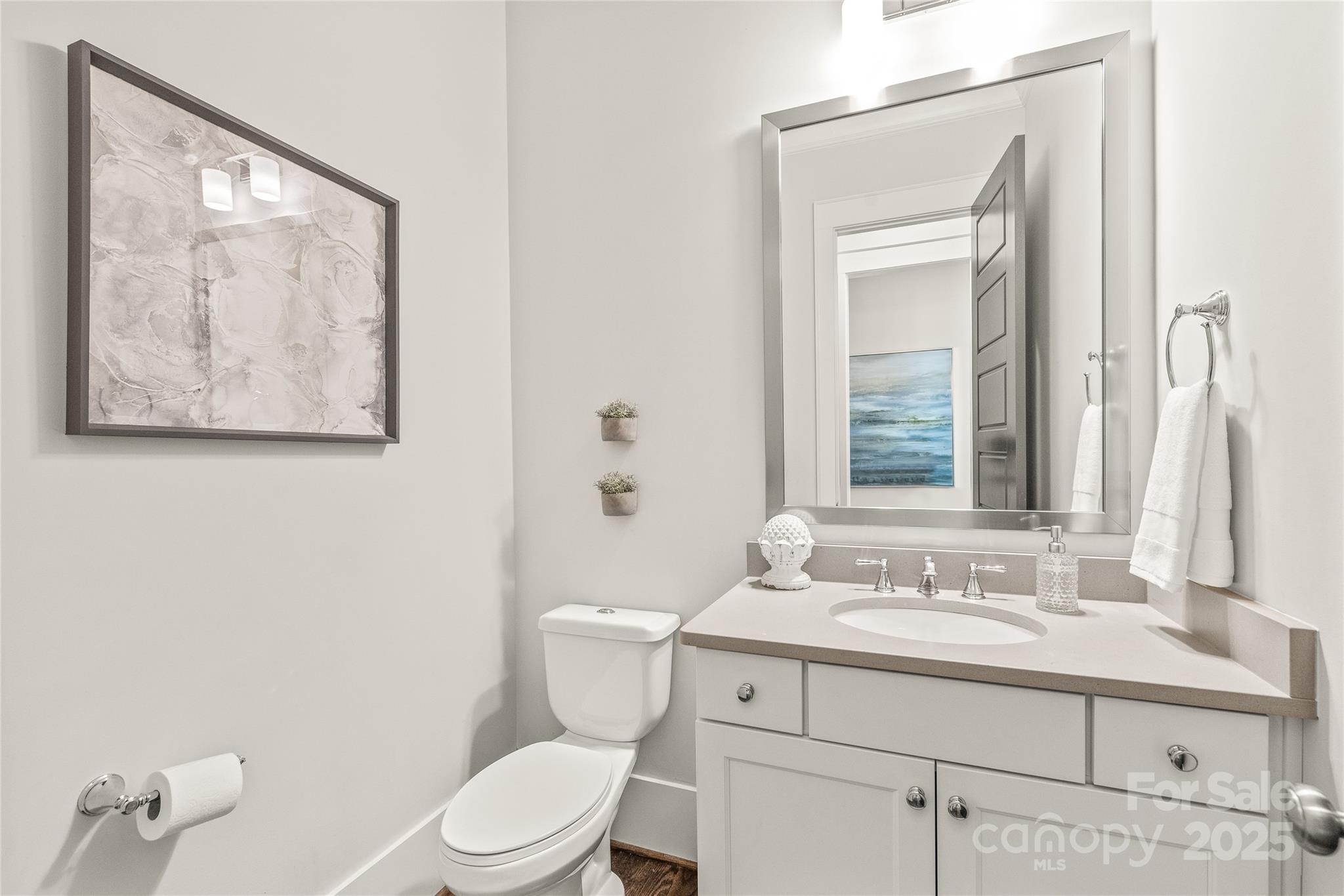 5717 Closeburn Road Charlotte, NC 28210 - Photo 16 of 40 a bathroom with a toilet a sink and mirror