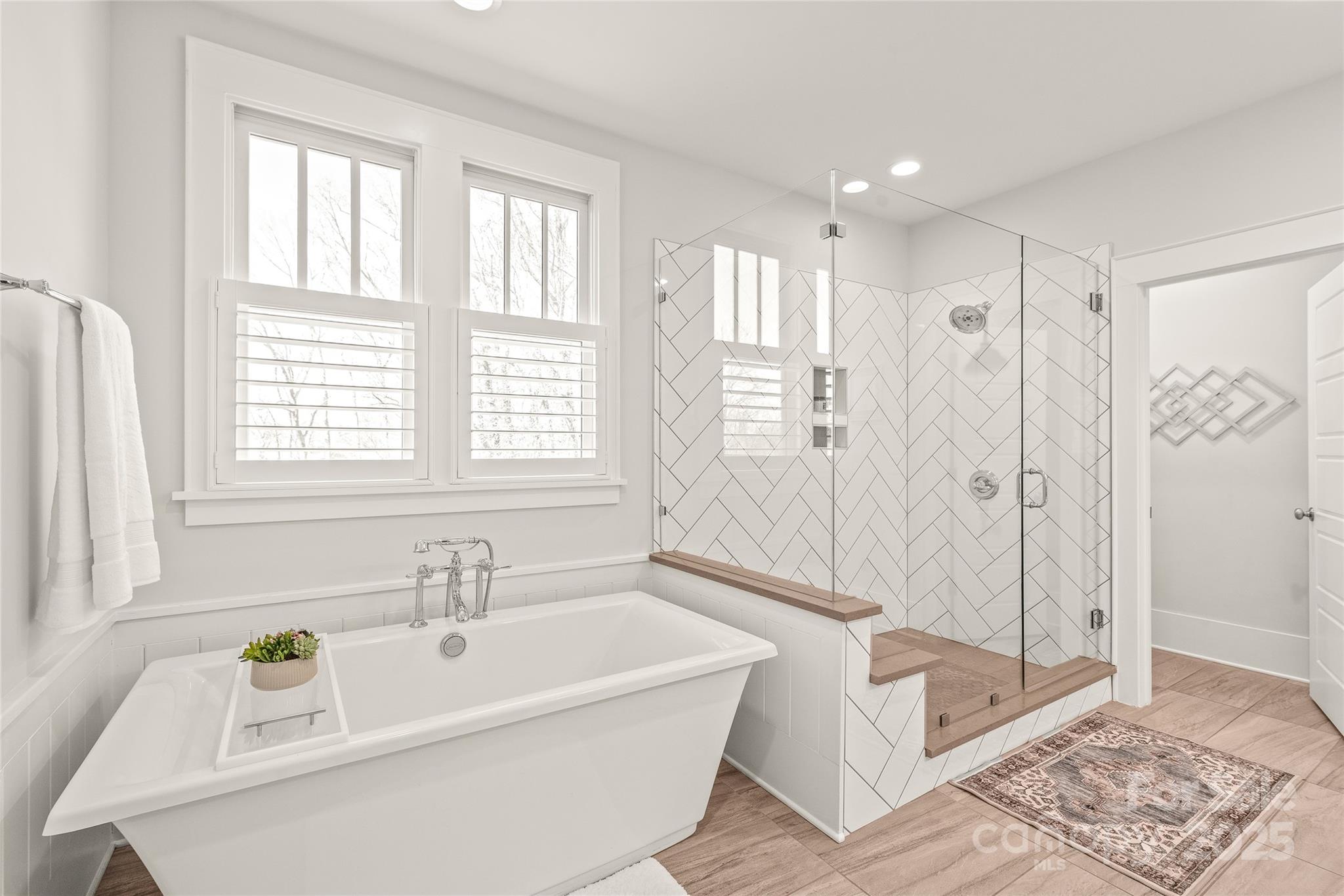 5717 Closeburn Road Charlotte, NC 28210 - Photo 22 of 40 a bathroom with a tub a sink and a window