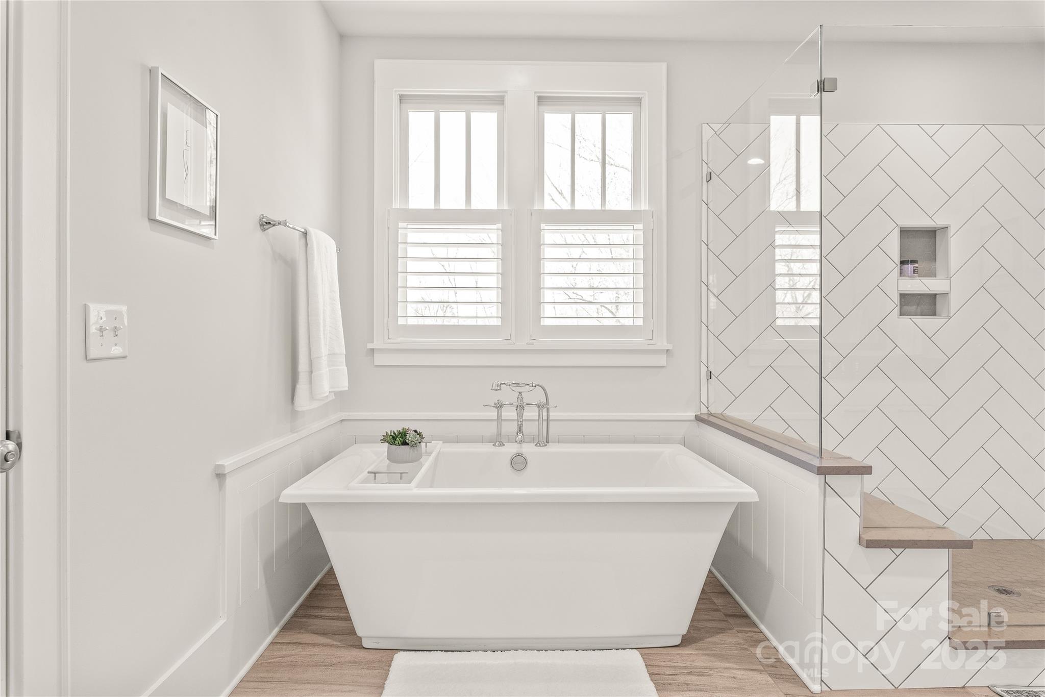 5717 Closeburn Road Charlotte, NC 28210 - Photo 24 of 40 a white bath tub sitting in a bathroom next to a window