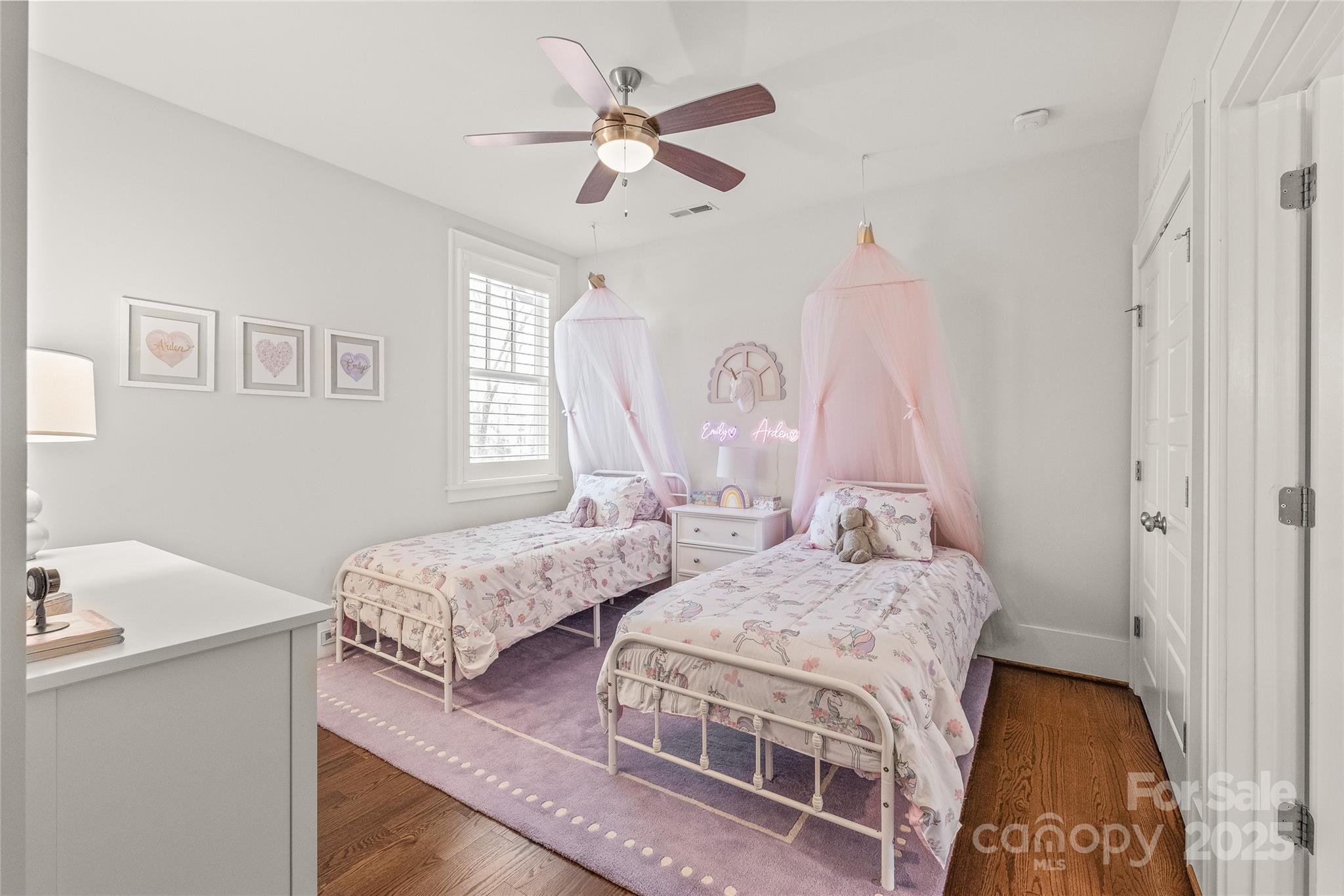 5717 Closeburn Road Charlotte, NC 28210 - Photo 27 of 40 a bedroom with two beds and a chandelier