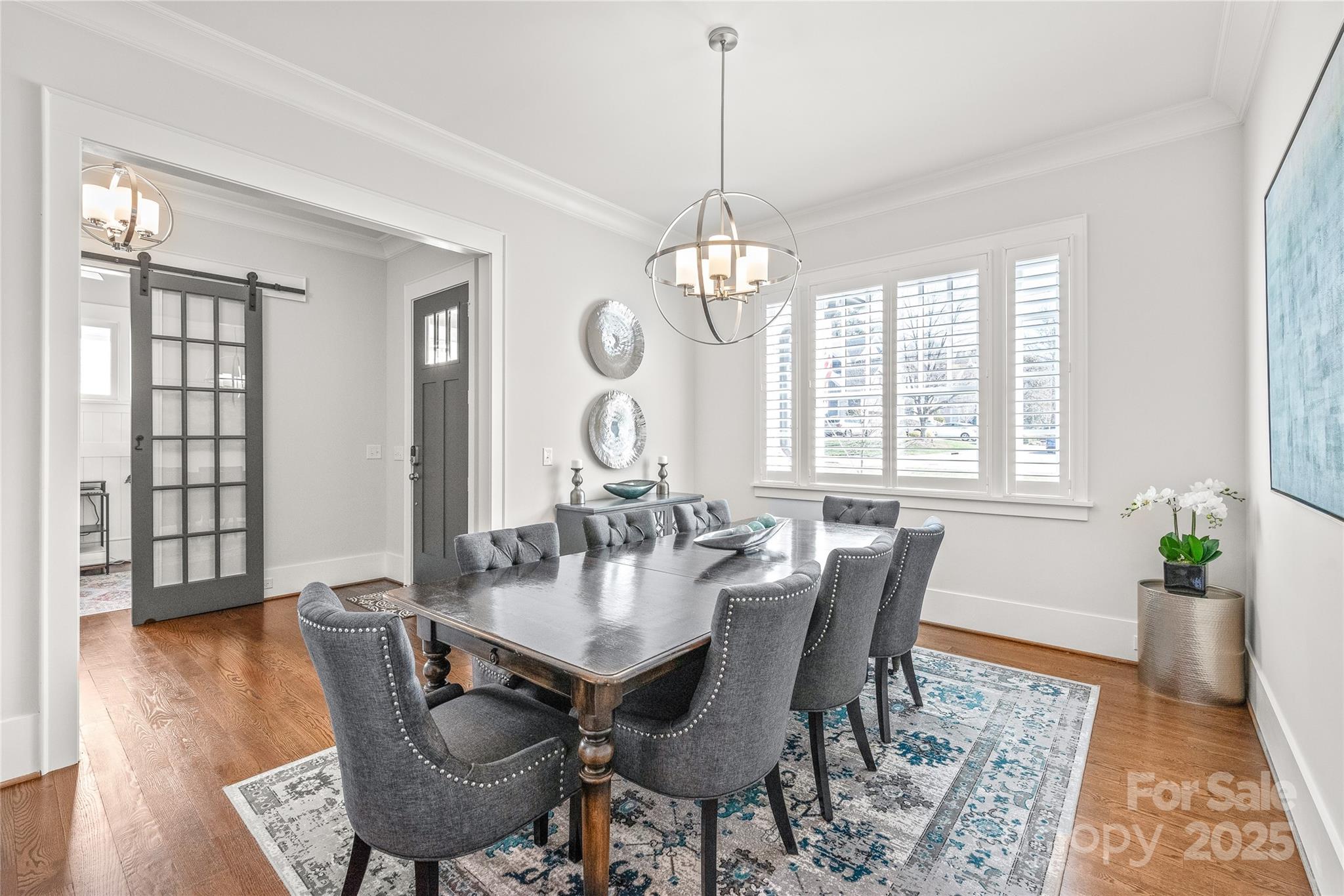 5717 Closeburn Road Charlotte, NC 28210 - Photo 4 of 40 a view of a dining room with furniture wooden floor and chandelier
