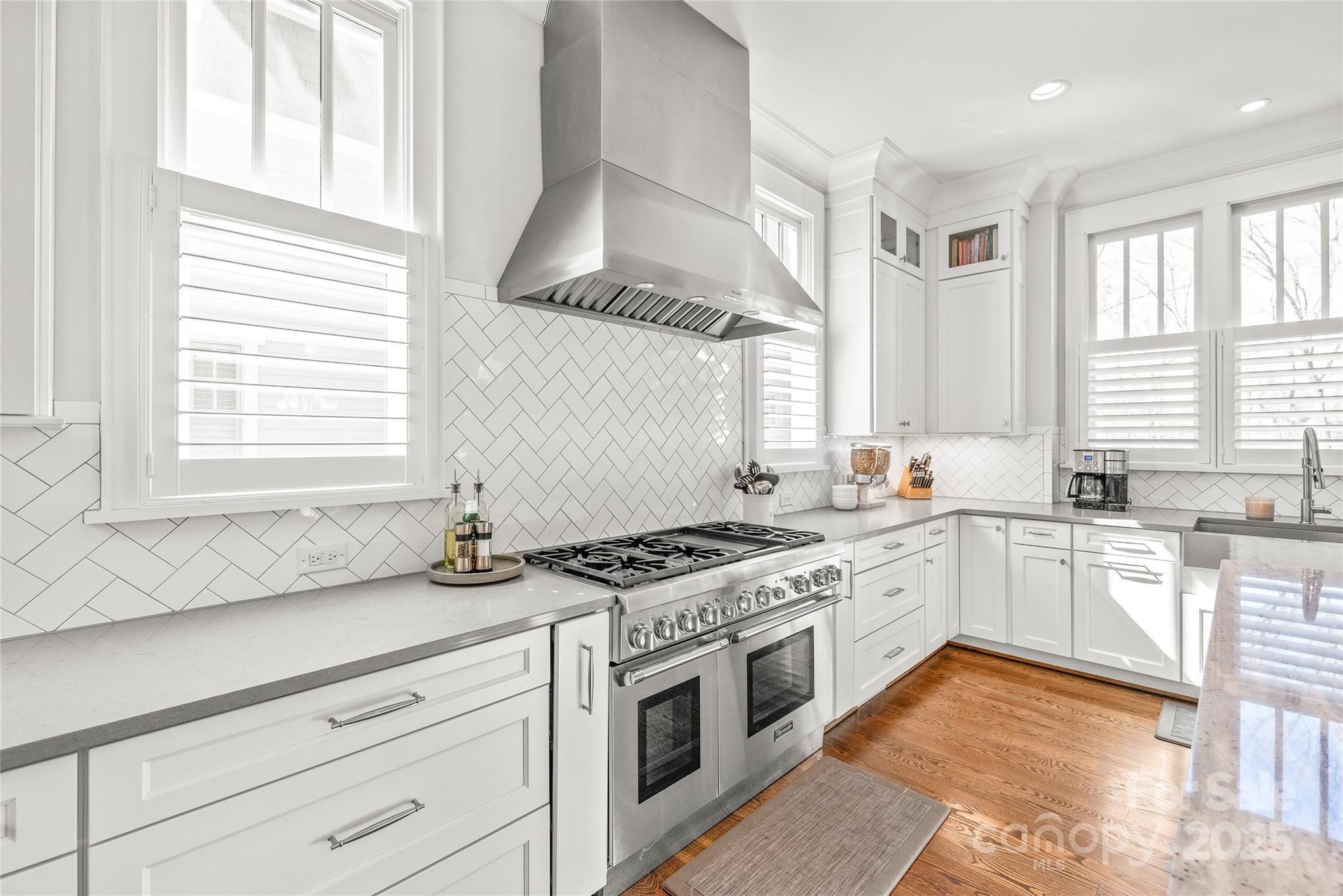5717 Closeburn Road Charlotte, NC 28210 - Photo 9 of 40 a kitchen with stainless steel appliances granite countertop white cabinets and window