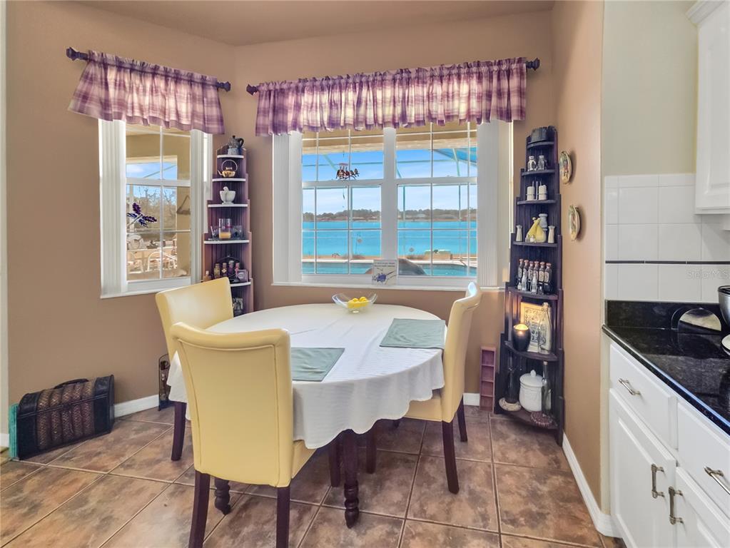 77 Hickory Loop Ocala, FL 34472 - Photo 15 of 50 a view of a dining room with furniture and a window