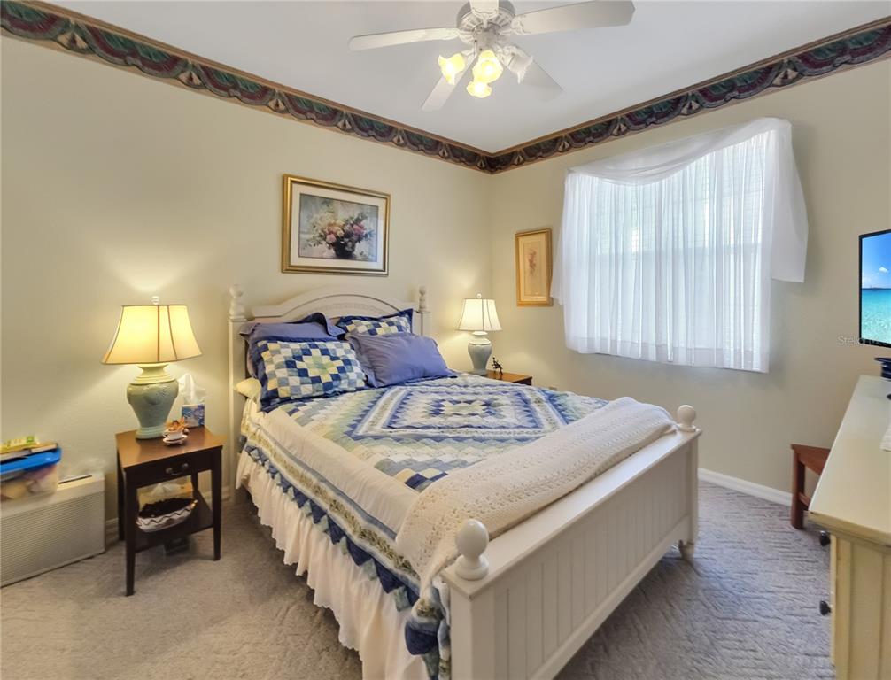 77 Hickory Loop Ocala, FL 34472 - Photo 26 of 50 a bedroom with a bed and a chandelier