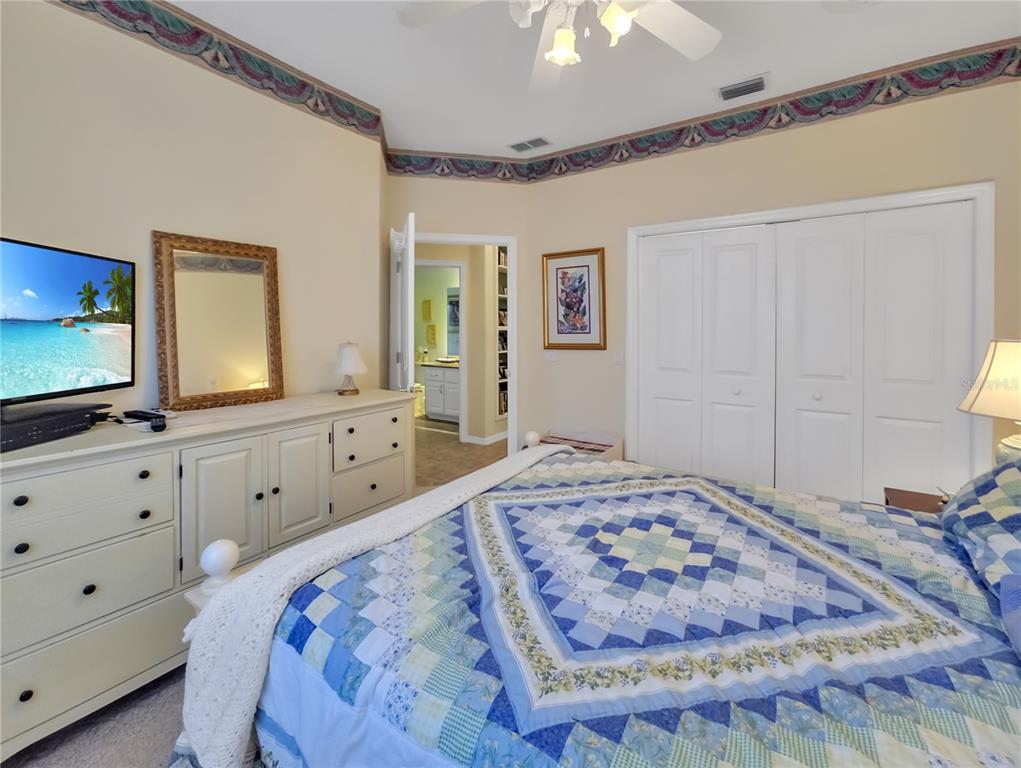 77 Hickory Loop Ocala, FL 34472 - Photo 27 of 50 a bedroom with a bed and a flat screen tv
