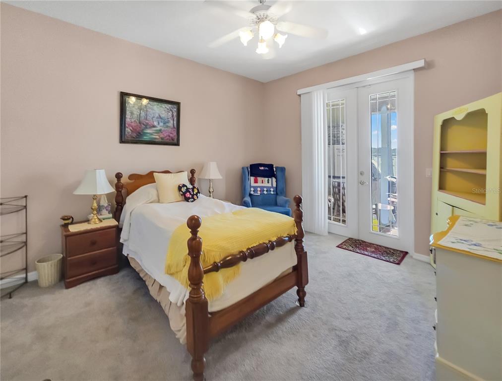 77 Hickory Loop Ocala, FL 34472 - Photo 28 of 50 a bed room with a bed and a chandelier