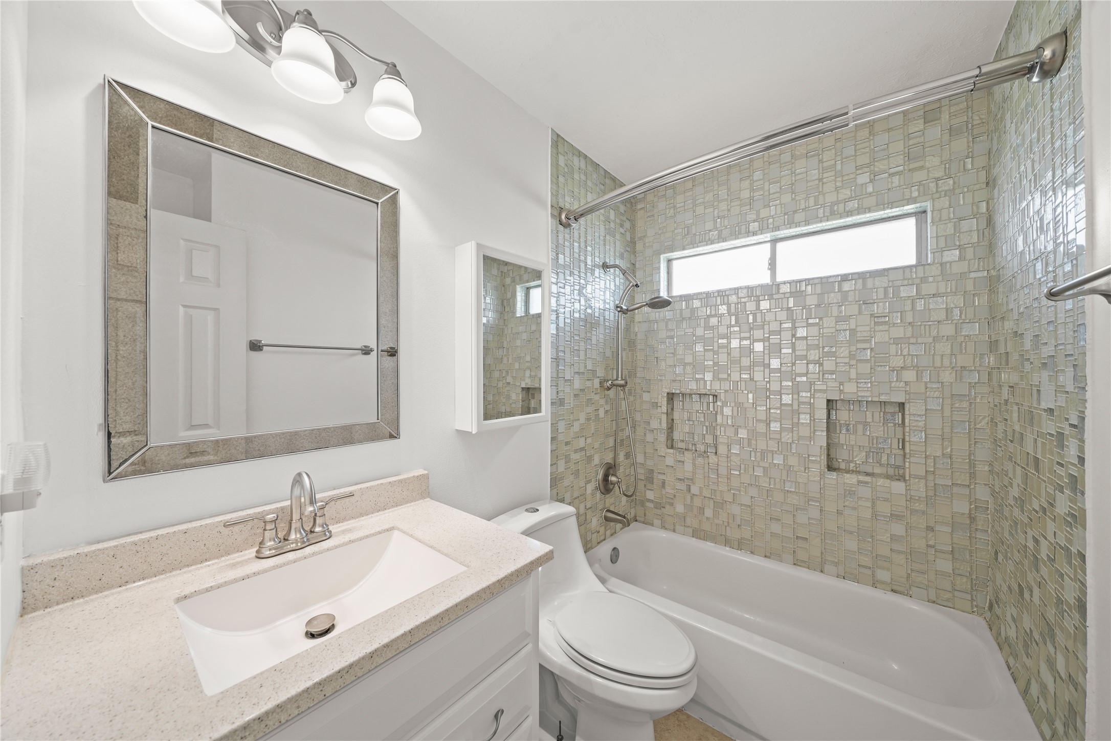 8134 Blue Jay Street Baytown, TX 77523 - Photo 25 of 31 The guest bathroom is thoughtfully designed with an expansive sink vanity, a soaking tub, providing a spa-like setting that blends comfort and functionality.