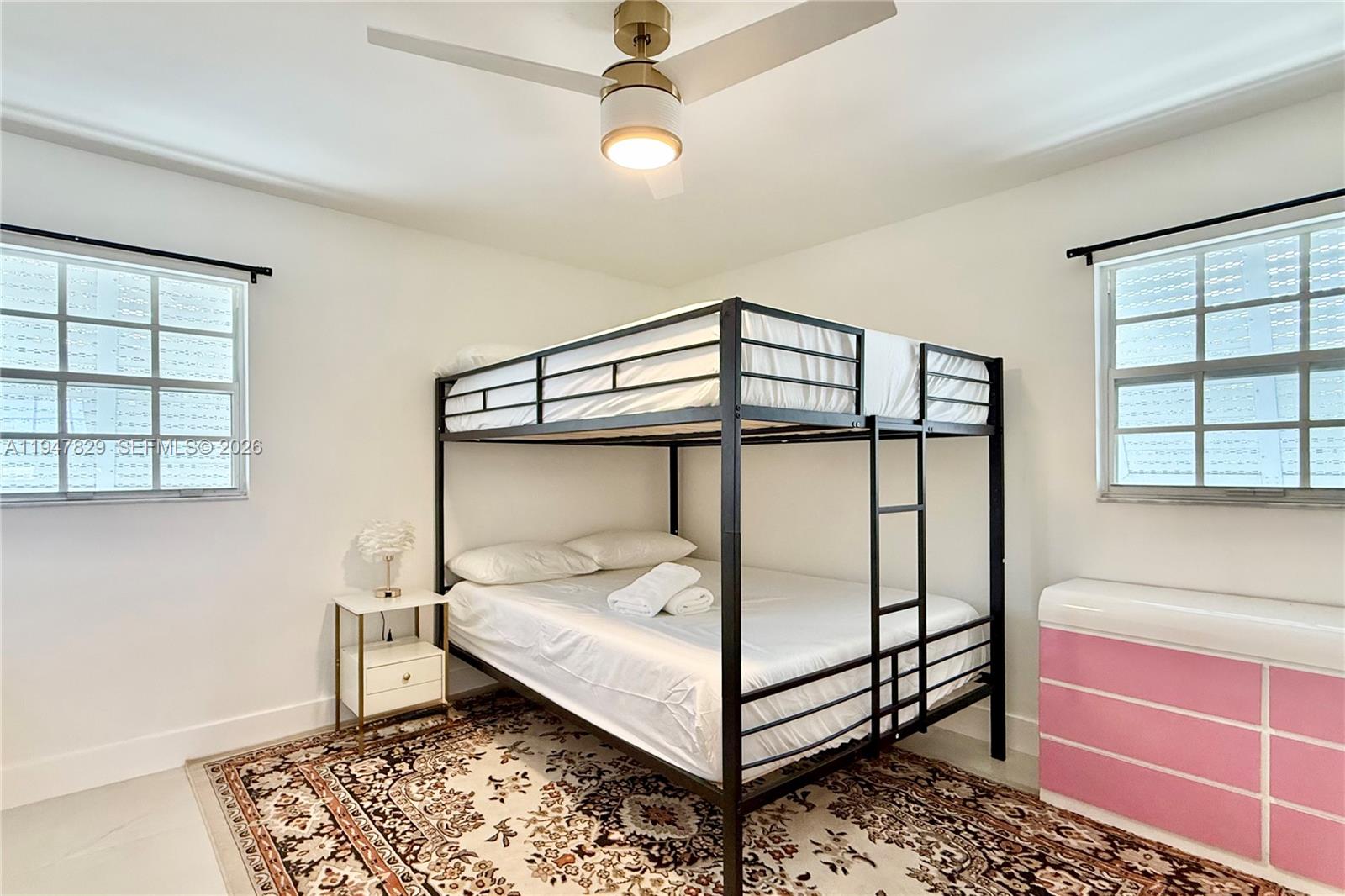 2216 R Northeast 18th Avenue, Unit RNT Wilton Manors, FL 33305 - Photo 14 of 16 a bedroom with a bed and a window