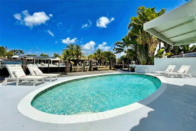 a view of a swimming pool with a patio