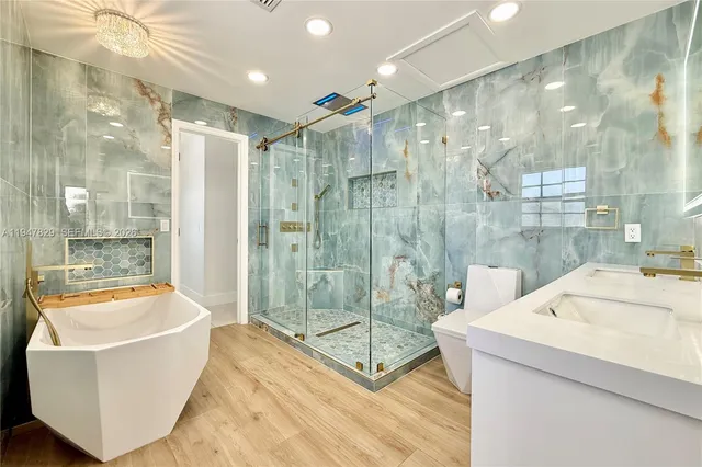 a bathroom with a tub a shower and sink