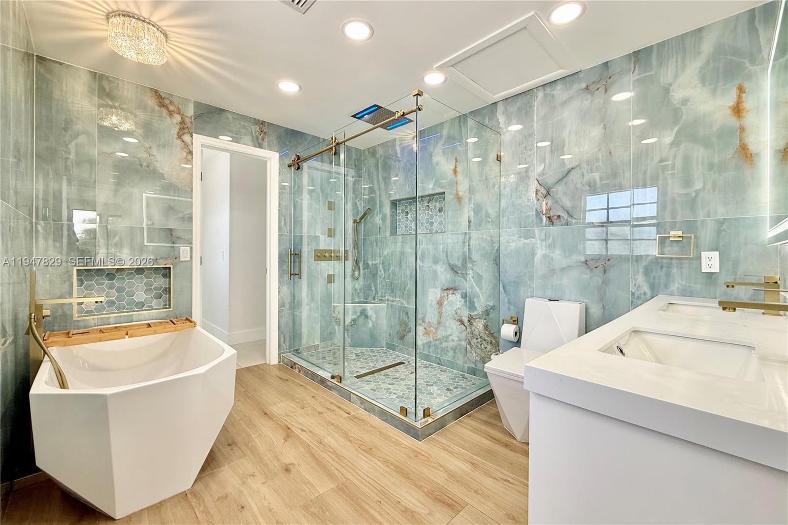 2216 R Northeast 18th Avenue, Unit RNT Wilton Manors, FL 33305 - Photo 9 of 16 a bathroom with a tub a shower and sink