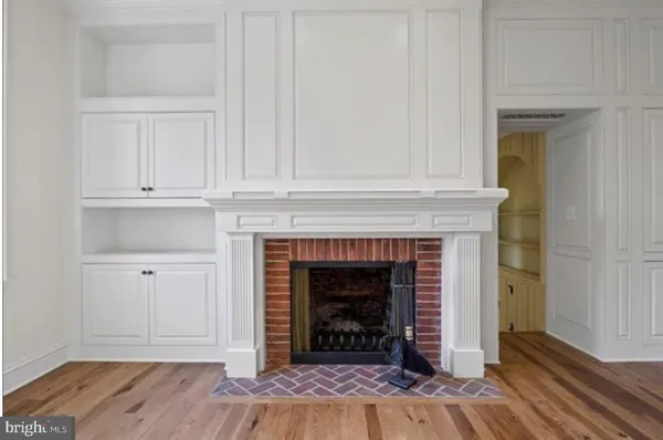 a view of a hallway with front door wooden floor and staircase