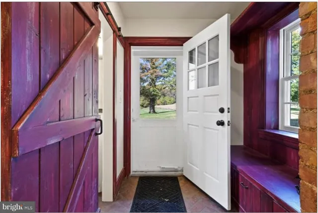 a bathroom with a granite countertop sink and a window