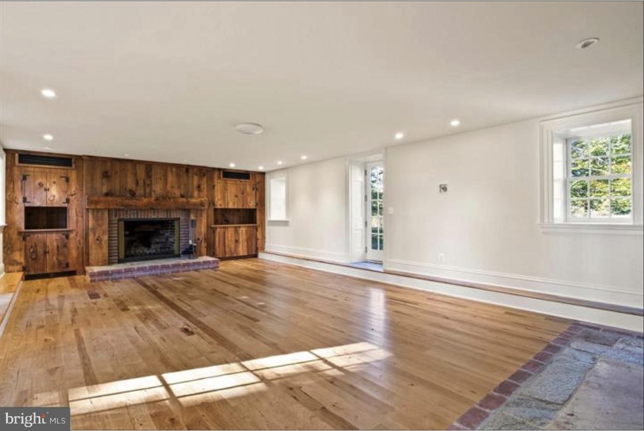 16131 Old York Road Monkton, MD 21111 - Photo 20 of 31 an empty room with wooden floor fireplace and windows