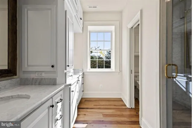 a view of a house with a big yard and large trees