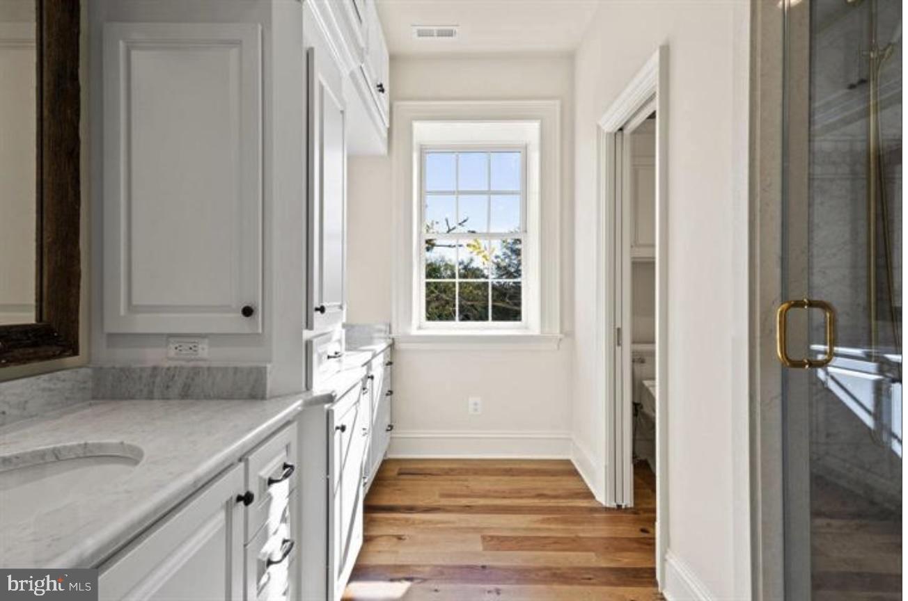 16131 Old York Road Monkton, MD 21111 - Photo 22 of 31 a bathroom with a granite countertop sink and a window