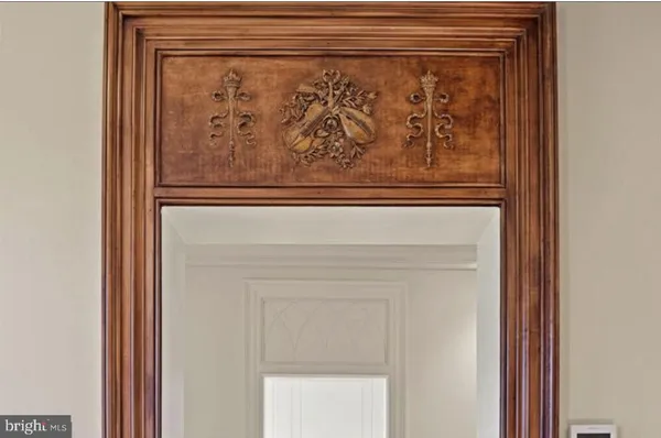 a view of a hallway with wooden floor and entryway