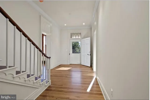 a kitchen with granite countertop a stove a sink and a refrigerator