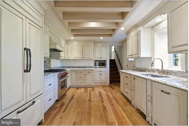 a view of empty room with wooden floor and fireplace