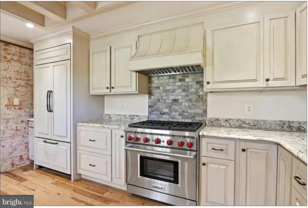 a view of an empty room with window and fire place