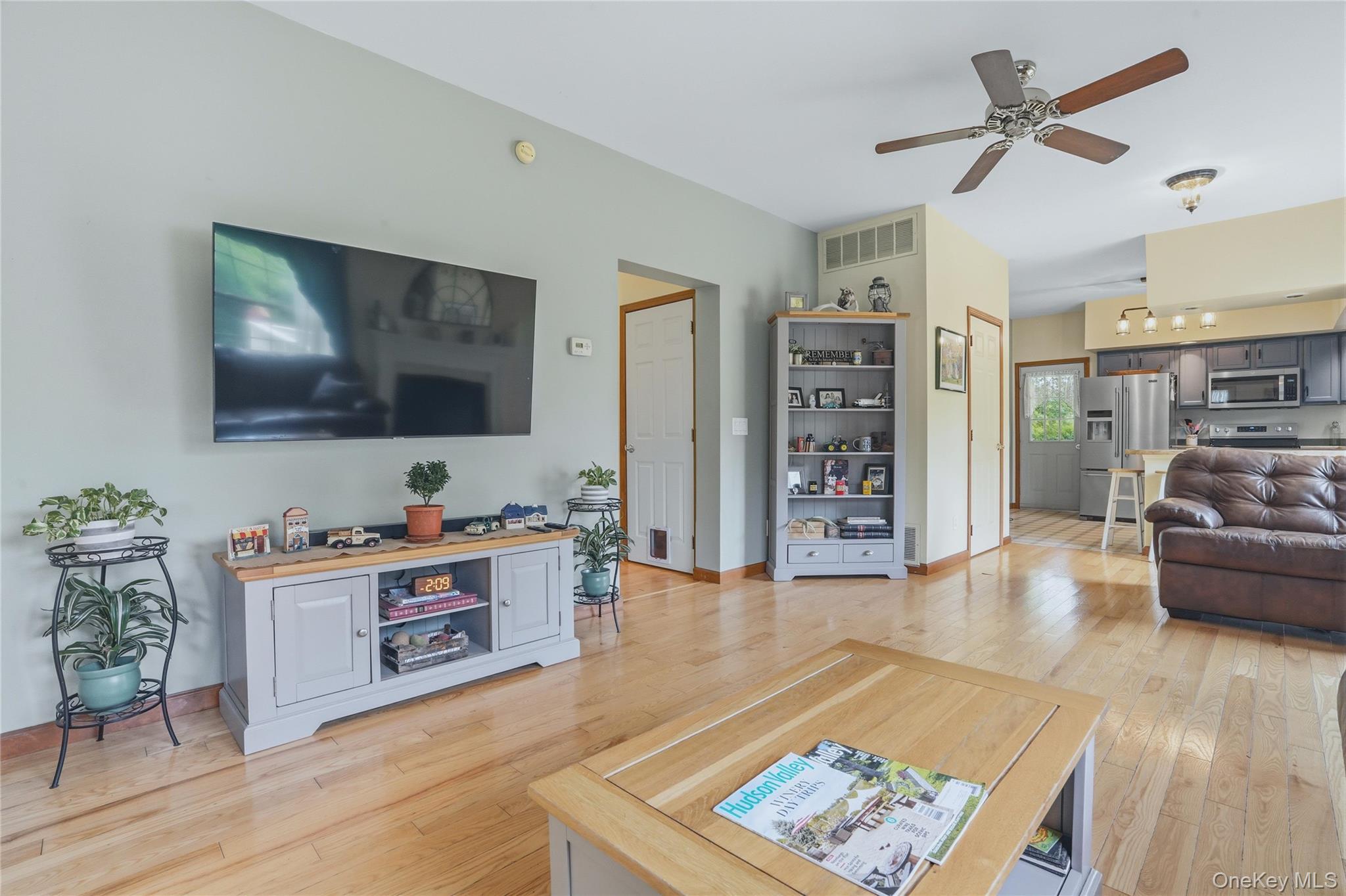 226 Cart Road, Unit C Dover Plains, NY 12522 - Photo 17 of 47 Open living room to kitchen with fireplace and wood floors