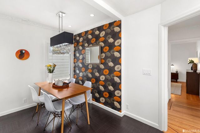 a view of a workspace with furniture and wooden floor